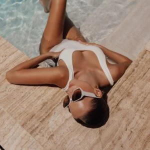 Woman in swimsuit relaxing in a luxurious swimming pool