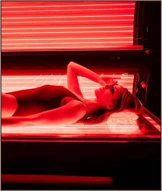 Woman wearing protective goggles undergoing red light therapy Woman wearing protective goggles undergoing red light therapy