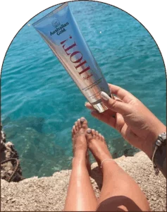 Hot! Hybrid tanning lotion bottle with scenic sea background Hot! Hybrid tanning lotion bottle with scenic sea background