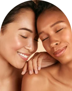 Close-up of two women with smooth, hydrated-looking skin and a soft, radiant glow.