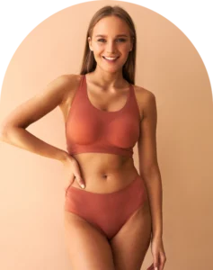 Woman with a natural-looking, sun-kissed spray tan against a neutral background