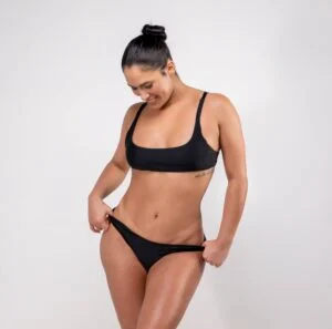 Woman in black swimwear showing an even, bronzed spray tan Woman in black swimwear showing an even, bronzed spray tan