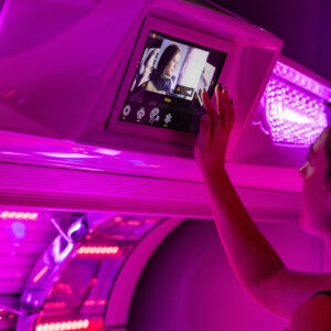 The Tanning Shop Ireland consultant setting session length and personalised features before a lie-down sunbed session