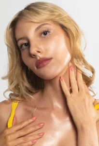 Woman with glowing skin following a WellFit skincare and Norvell spray tan session. Woman with glowing skin following a WellFit skincare and Norvell spray tan session.