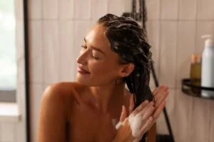 Woman showering after a spray tan. Woman showering after a spray tan.